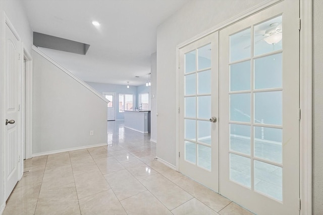 hallway with french doors and light tile patterned flooring