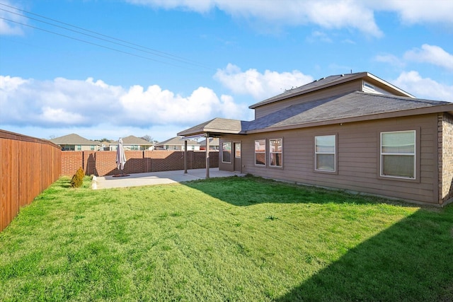 rear view of property featuring a patio area and a lawn