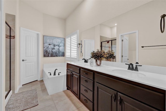 bathroom with tile patterned flooring, a sink, a shower stall, and double vanity