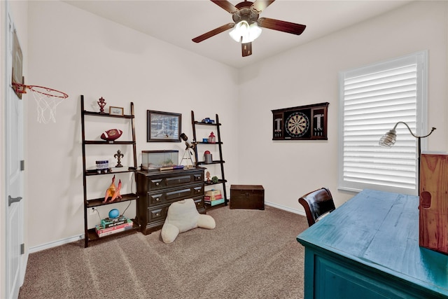 carpeted office featuring a ceiling fan and baseboards