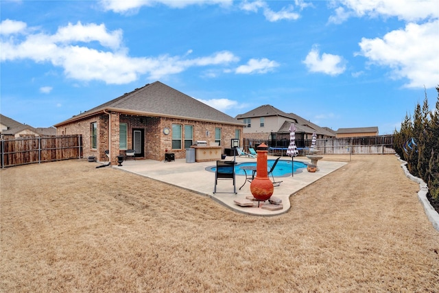 view of swimming pool with a fenced in pool, a patio area, a lawn, and a fenced backyard