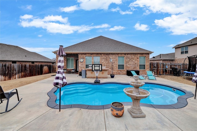 view of pool with a fenced backyard and a patio