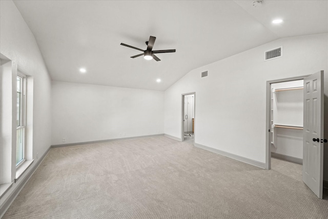 carpeted empty room featuring lofted ceiling and ceiling fan