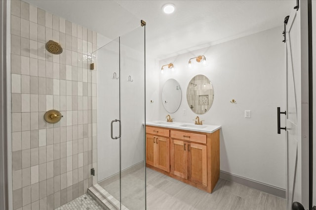 bathroom with vanity and a shower with door