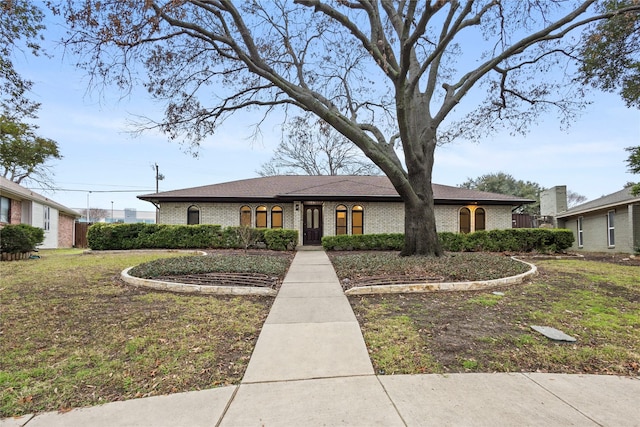 ranch-style house with a front lawn