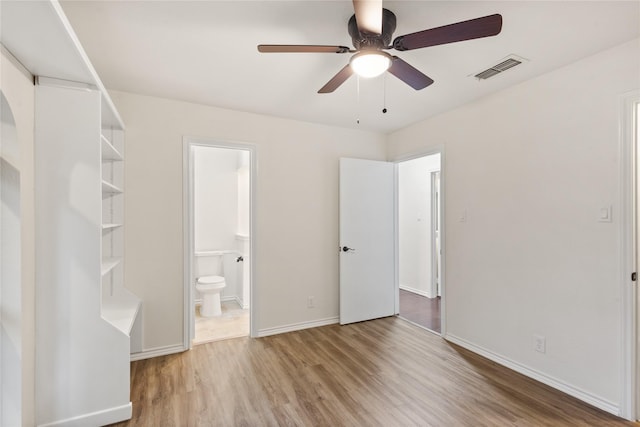 unfurnished bedroom with connected bathroom, ceiling fan, and wood-type flooring