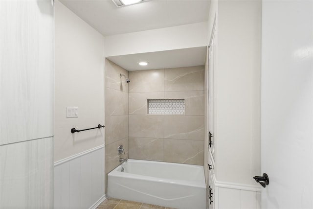 bathroom featuring tiled shower / bath combo and tile patterned flooring