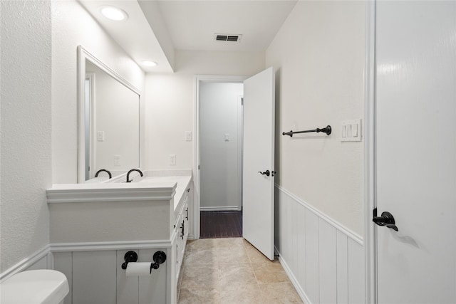 bathroom featuring toilet and vanity