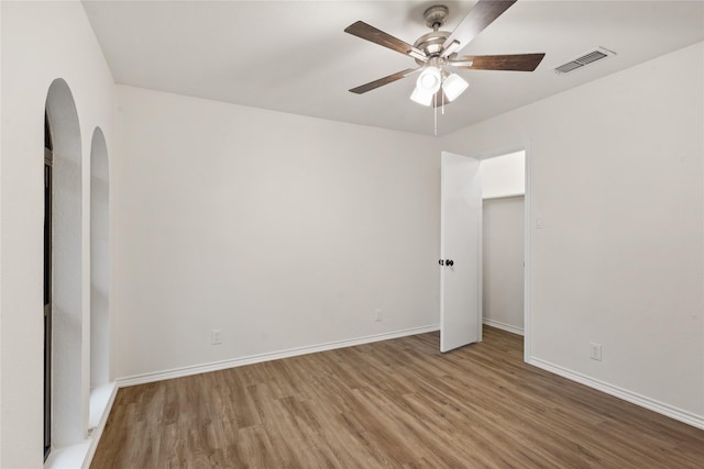 interior space with ceiling fan and wood-type flooring