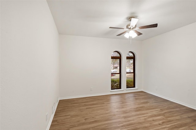 spare room with ceiling fan and wood-type flooring