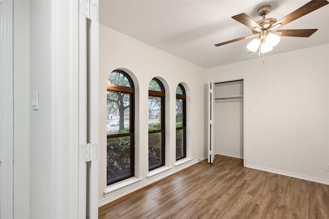 unfurnished bedroom featuring ceiling fan and hardwood / wood-style floors