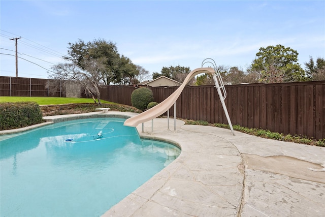 view of swimming pool with a water slide