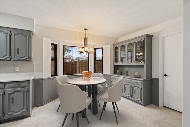 dining space with an inviting chandelier and light tile patterned floors