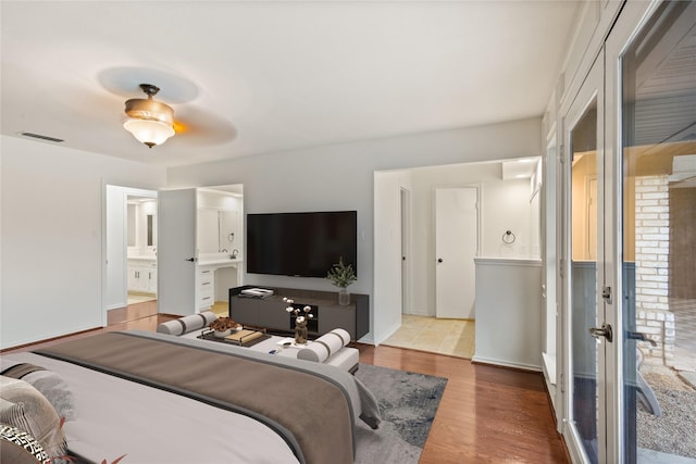 bedroom with wood-type flooring and ensuite bathroom