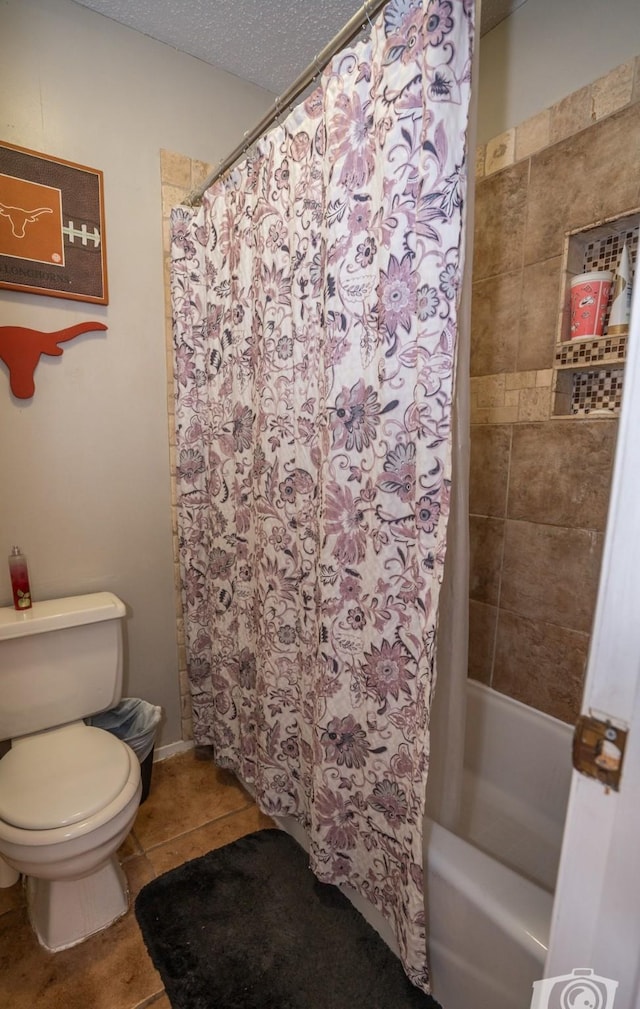 bathroom featuring toilet, tile patterned flooring, a textured ceiling, and shower / bath combination with curtain