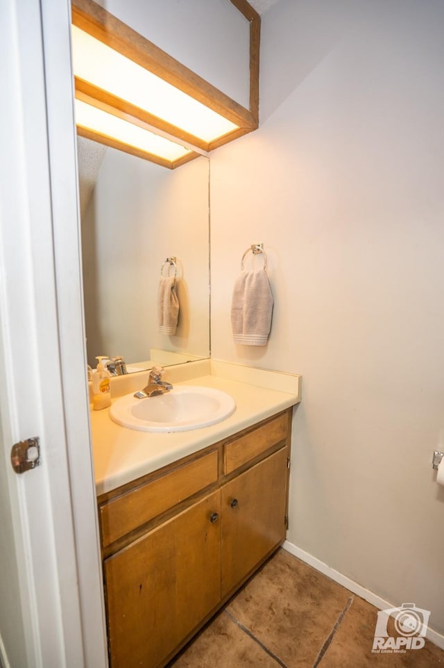 bathroom featuring tile patterned flooring and vanity