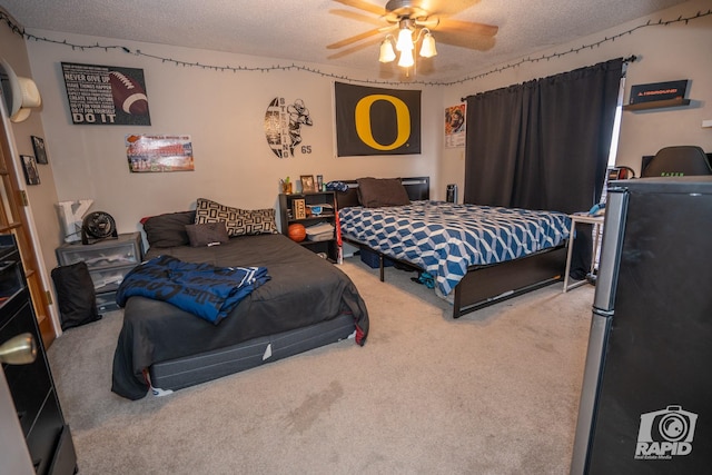 carpeted bedroom featuring ceiling fan, stainless steel refrigerator, and a textured ceiling