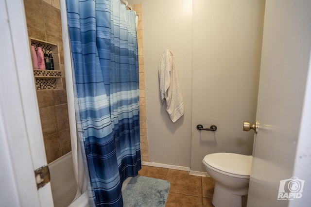 bathroom featuring shower / tub combo with curtain, toilet, and tile patterned floors