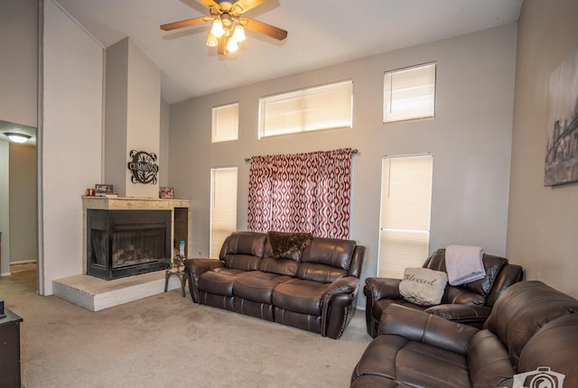 living room with ceiling fan, high vaulted ceiling, and carpet