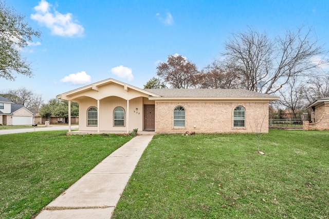 view of front of home with covered porch, brick siding, a shingled roof, fence, and a front yard