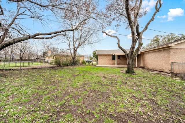 view of yard featuring a patio and fence