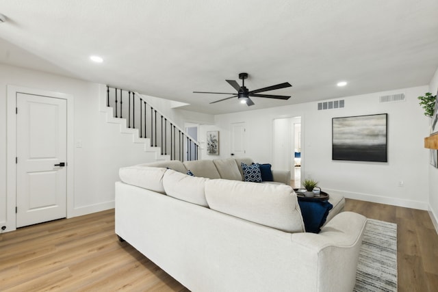 living room with light wood-type flooring and ceiling fan