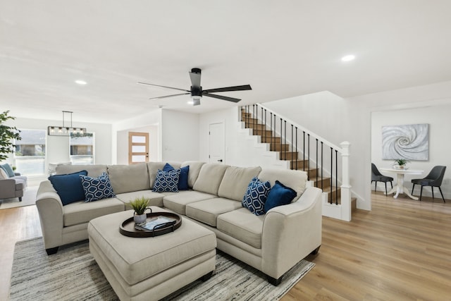 living room with light wood-type flooring and an inviting chandelier