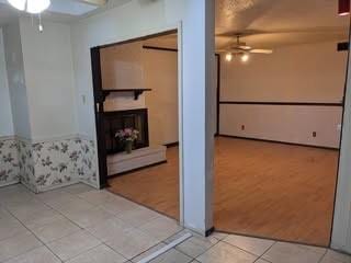 tiled spare room featuring ceiling fan