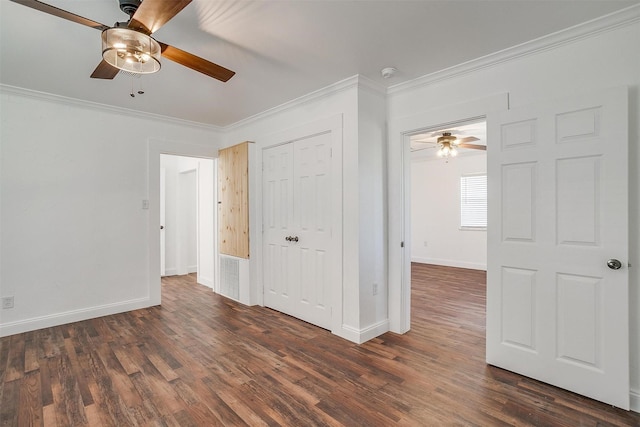 unfurnished room featuring ceiling fan, crown molding, and dark wood-type flooring