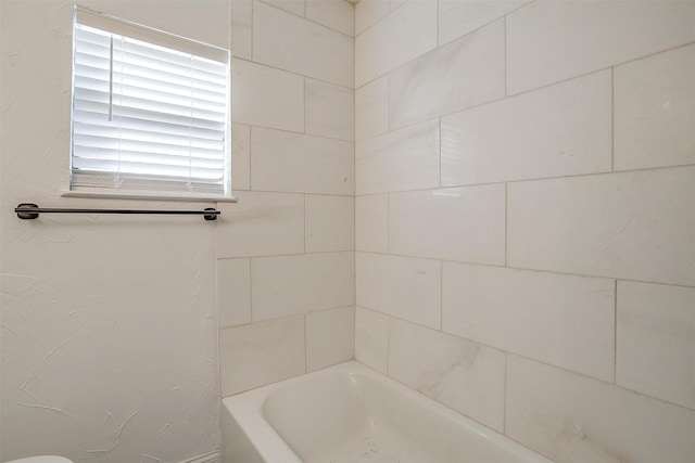 bathroom featuring a washtub