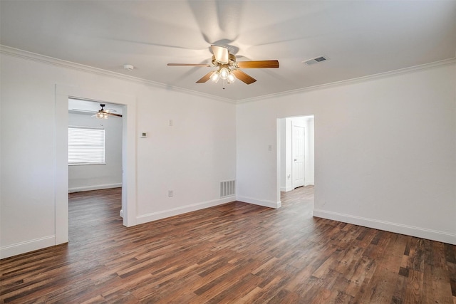 spare room featuring dark hardwood / wood-style flooring, ornamental molding, and ceiling fan