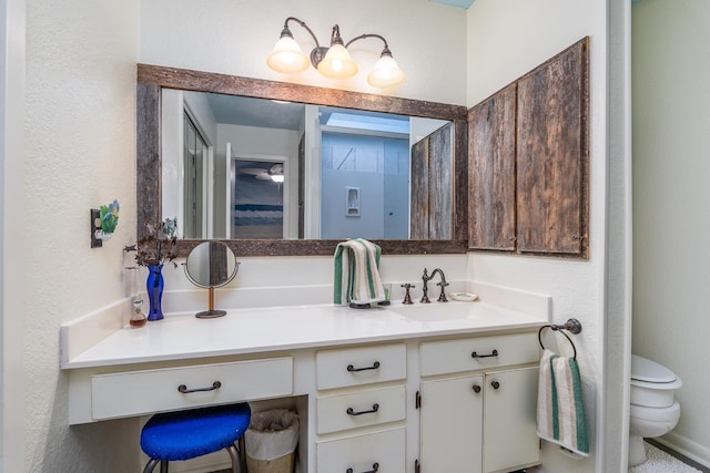 bathroom featuring vanity and toilet