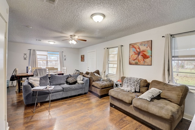 living room featuring ceiling fan, a textured ceiling, and hardwood / wood-style floors