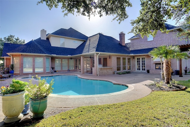 1306 Lexington Sq, Southlake, TX 76092 - swimming pool featuring french doors, a patio area, ceiling fan, and a lawn