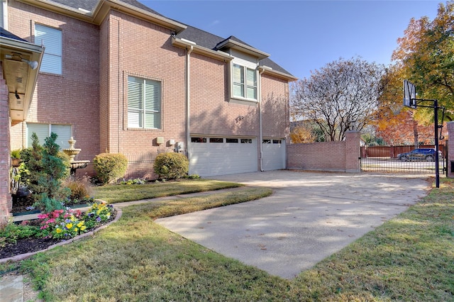 1306 Lexington Sq, Southlake, TX 76092 - view of side of property with driveway, a garage, brick siding, and a gate