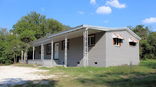 view of front facade with a porch and brick siding