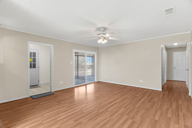 spare room with light wood-type flooring, crown molding, a textured ceiling, and ceiling fan