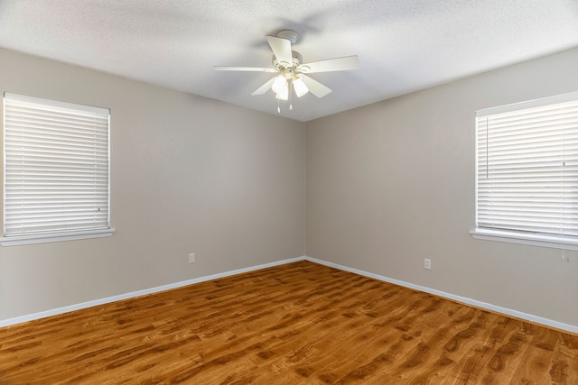 unfurnished room with a textured ceiling, hardwood / wood-style flooring, and ceiling fan