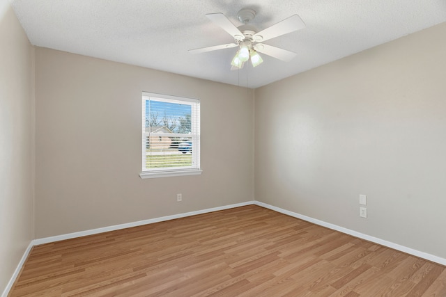 unfurnished room with ceiling fan, light hardwood / wood-style floors, and a textured ceiling