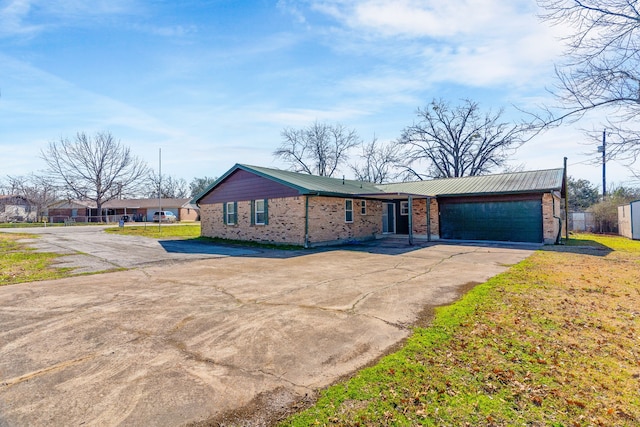 ranch-style home with a garage and a front lawn