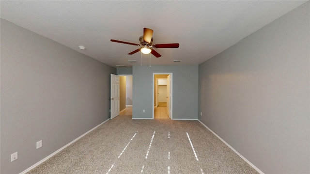 unfurnished bedroom with visible vents, ceiling fan, ensuite bath, and baseboards