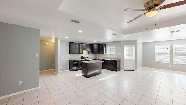 kitchen featuring stainless steel range with electric stovetop, visible vents, light countertops, and a center island