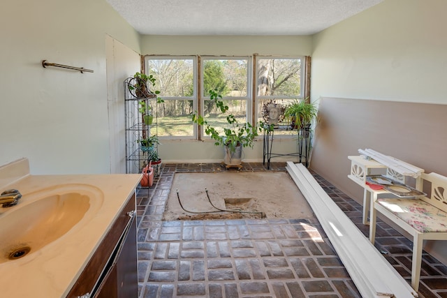 bathroom with vanity and a textured ceiling