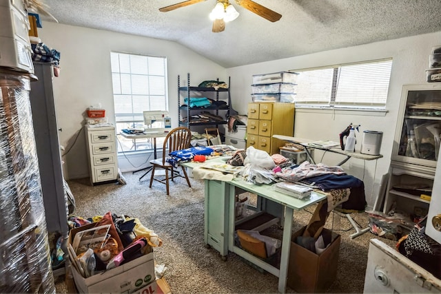 carpeted home office featuring a textured ceiling, lofted ceiling, and ceiling fan