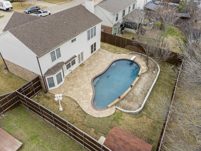 view of swimming pool with a patio, a diving board, a fenced backyard, and a fenced in pool