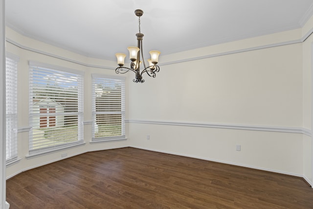 unfurnished dining area with a chandelier, dark hardwood / wood-style flooring, and ornamental molding