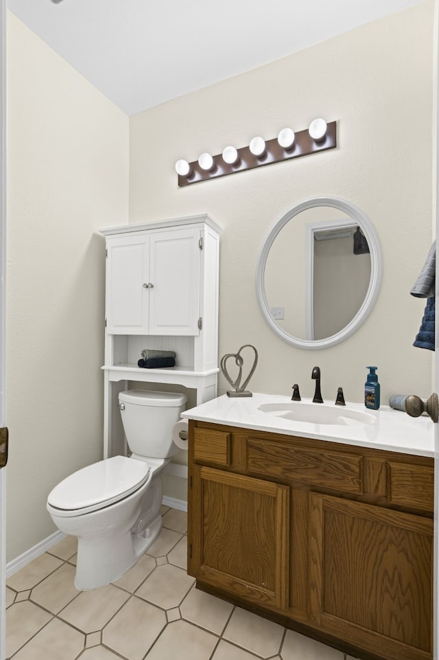 bathroom featuring tile patterned flooring, vanity, and toilet