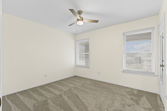 empty room with carpet, ceiling fan, and a healthy amount of sunlight