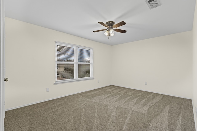 carpeted empty room featuring ceiling fan