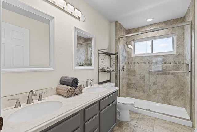 bathroom with toilet, tile patterned floors, vanity, and walk in shower